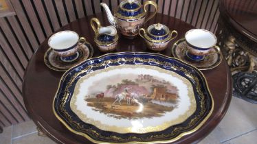 A 19th century hand painted Vienna cabaret set in royal blue with gilt decoration and scenes of