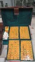 A vintage Mahjong set in leather case with four counter trays and table matt