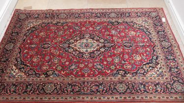 A hand knotted woollen Kashan rug - 2.18m x 1.35m