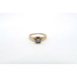 An illusion set 14ct yellow gold and diamond solitaire ring with chip - ring size M - 1.9 grams
