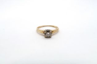 An illusion set 14ct yellow gold and diamond solitaire ring with chip - ring size M - 1.9 grams