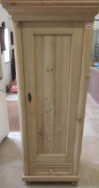 A stripped pine cabinet with shelves and bottom drawer, lock and key - 174cm x 70cm x 52cm