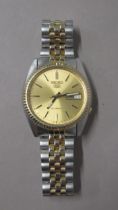 SEIKO. Automatic. Modern gold dial. 35mm. Day date, working in saleroom. Spare links