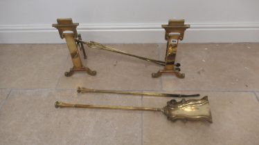 A set of brass fire dogs and three irons