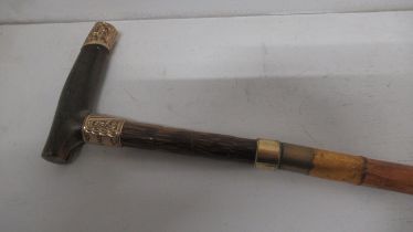 A walking stick with a plated top