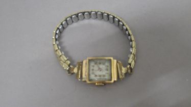 A ladies 18ct (hallmarked) yellow gold cased Reflux wristwatch on plated strap - not working