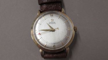 A gents 9ct gold cased Omega automatic wristwatch - 35mm case - working in the saleroom