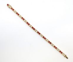 A diamond and ruby tennis bracelet set in 18ct (hallmarked) yellow gold - 22 round brilliant cut