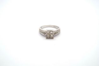 An 18ct white gold and diamond ring - Four central square cut diamonds each approx 0.15-0.2ct -