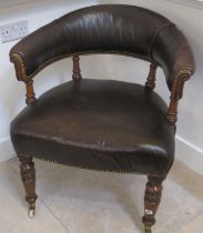 A good quality 19th century library chair covered in brown leather on turned legs