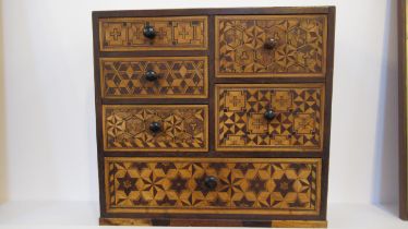 A marquetry jewellery cabinet with six random sized drawers - 30cm x 30cm