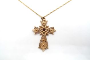 A 9ct yellow gold hallmarked filigree cross pendant with red garnet, approx 3.5cm, on a 9ct yellow