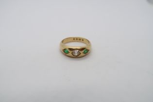 A hallmarked 18ct yellow gold diamond and emerald gypsy ring, size R/S, approx 8.5 grams
