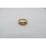 A hallmarked 18ct yellow gold diamond and emerald gypsy ring, size R/S, approx 8.5 grams