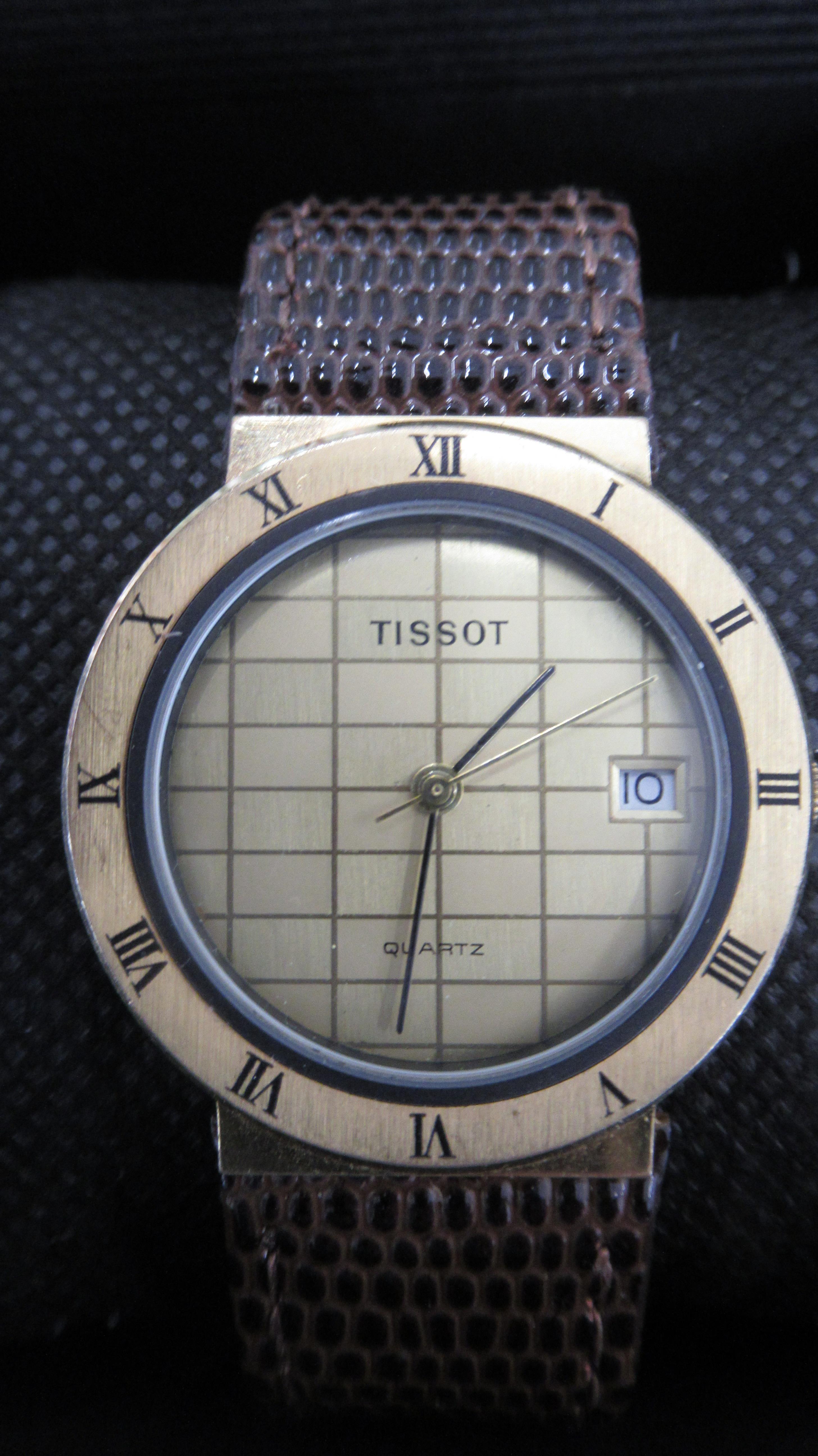 A Tissot quartz gold face watch with date on brown leather strap - 30mm face - working in the