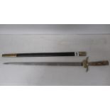 A 19th century German hunting sword with antler grip and brass mounts and etched blade, 49cm, in