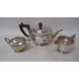 A Mappin and Webb cast silver three piece tea set - Tea pot, cream jug and sugar bowl - tea pot 25cm