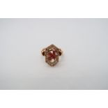 An approx 18ct (tested) yellow gold diamond and ruby ring - the head with open work as initials '