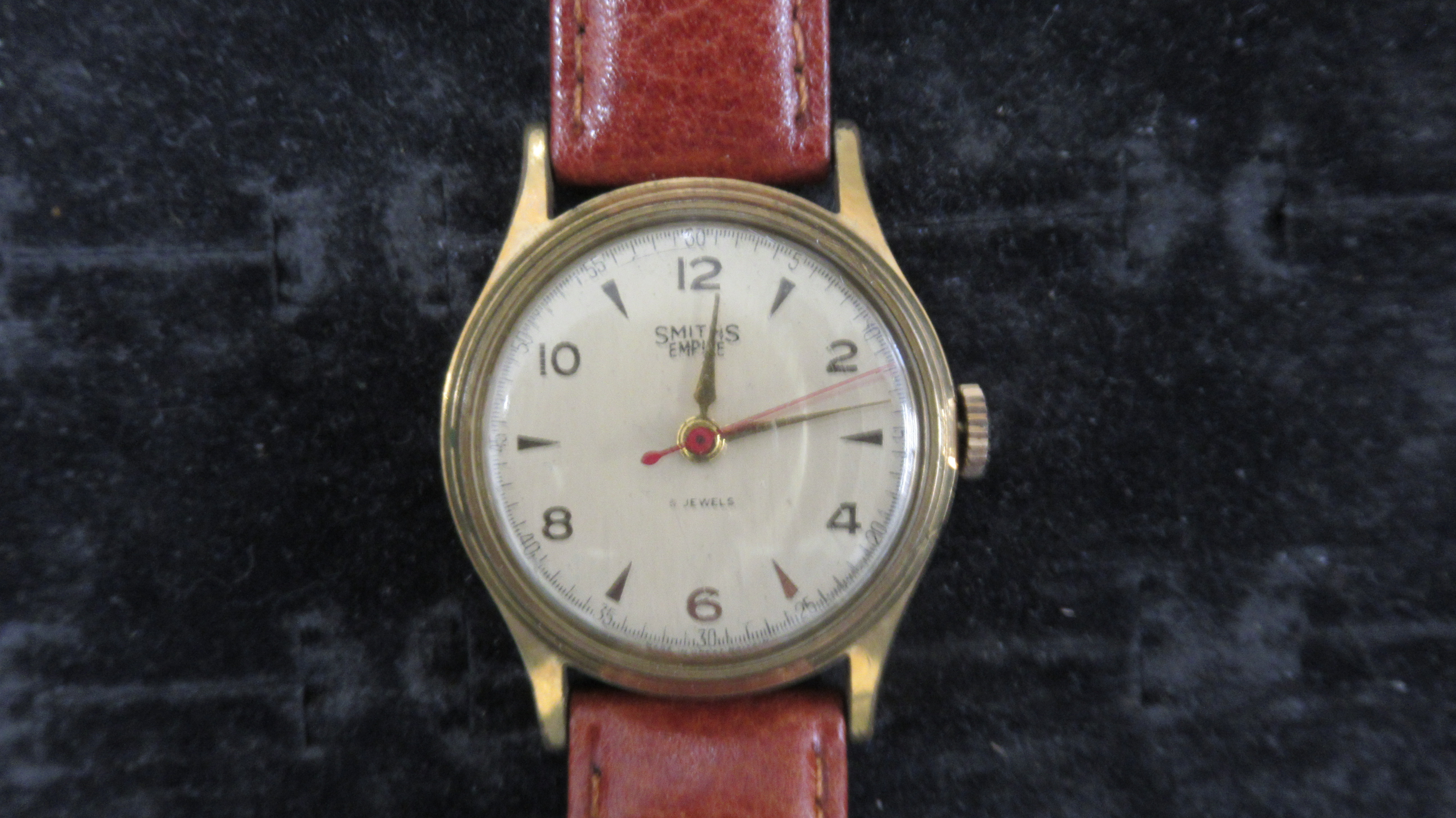 A Smiths Empire manual wind Gents watch on a leather strap, working in saleroom