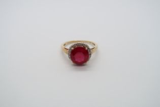 A 9ct yellow gold ruby and diamond ring, head size 12mm diameter, ring size N/O