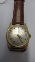 A gents Onsa auto with date and second hand on brown leather strap - working in the saleroom -