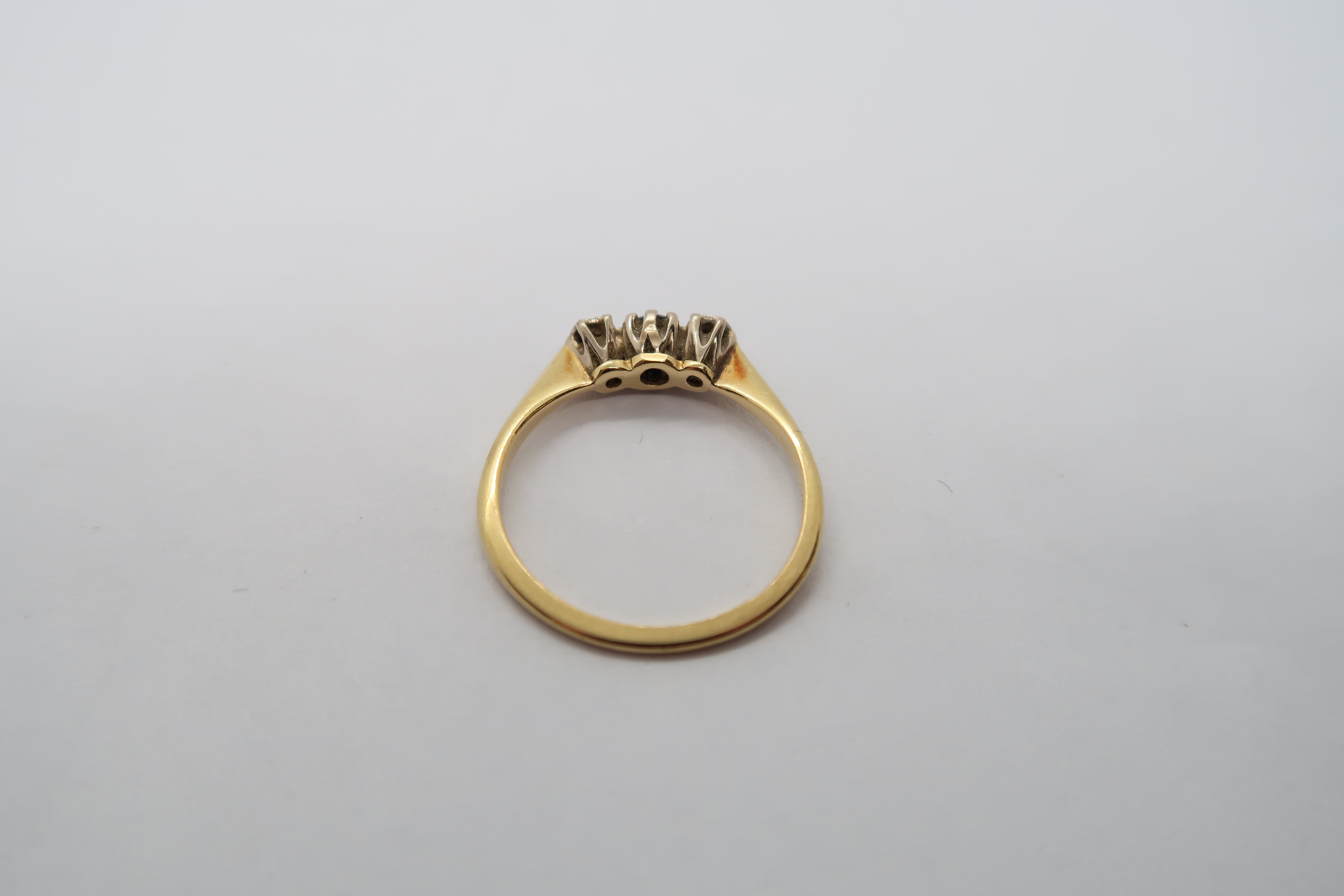An 18ct hallmarked yellow gold three stone ring with diamonds and garnet, size L, approx 2 grams - Image 3 of 3