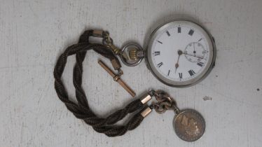 A silver cased open face pocket watch 5cm diameter, ticking together with cord with chain with T bar