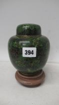 A green enamel ginger jar on stand