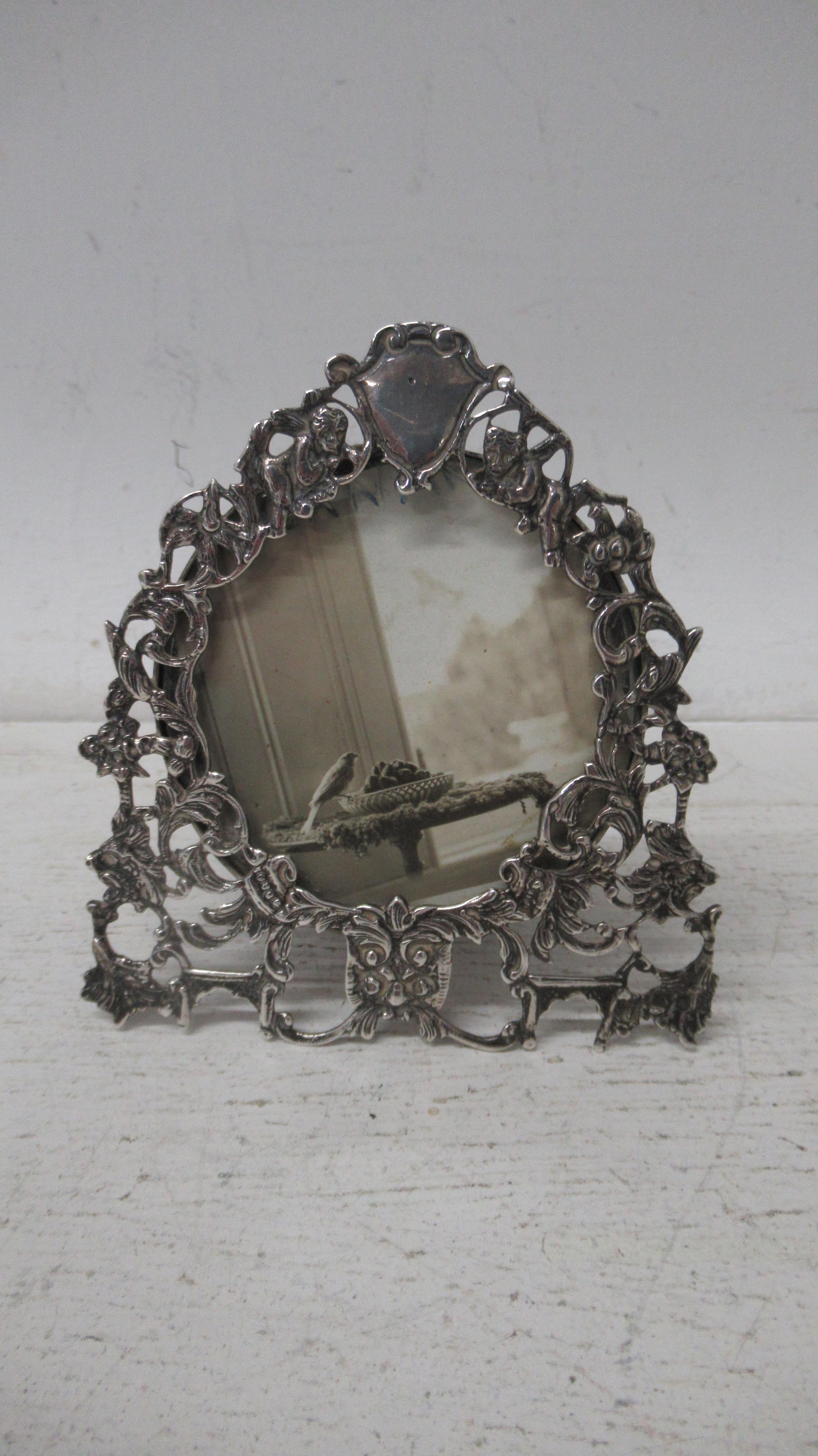 A late Victorian silver photo frame Goldsmiths and Silversmiths Co London 1897 with scrolled and