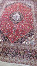 A hand knotted woollen Kashan rug - 3.56m x 2.37m