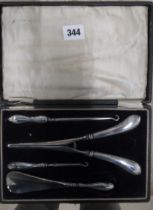 A cased set of glove stretchers, shoe horn etc with silver handles