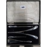 A cased set of glove stretchers, shoe horn etc with silver handles