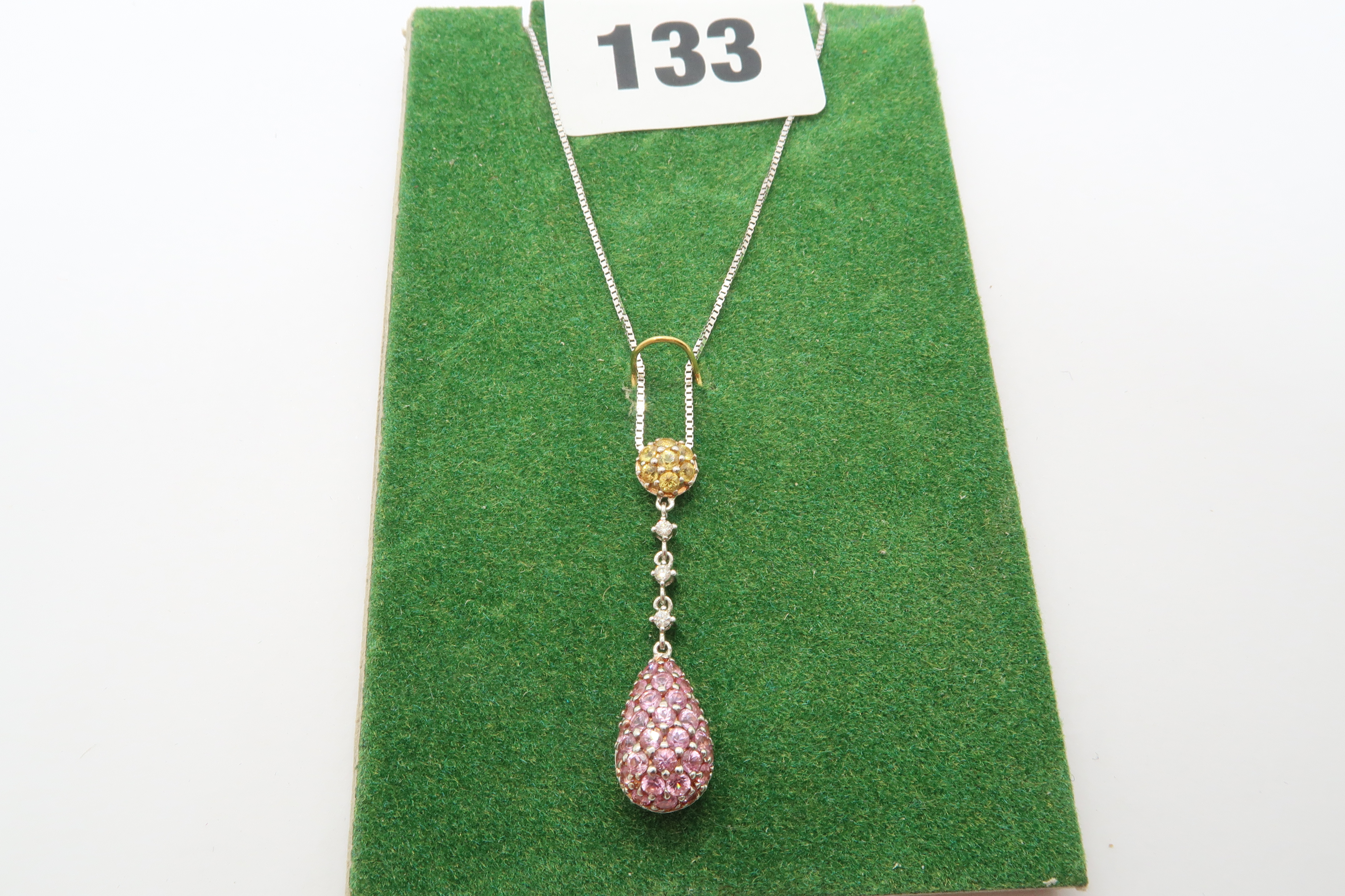 A 9ct white gold pink and yellow sapphire drop pendant - ex jewellers stock, as new condition -