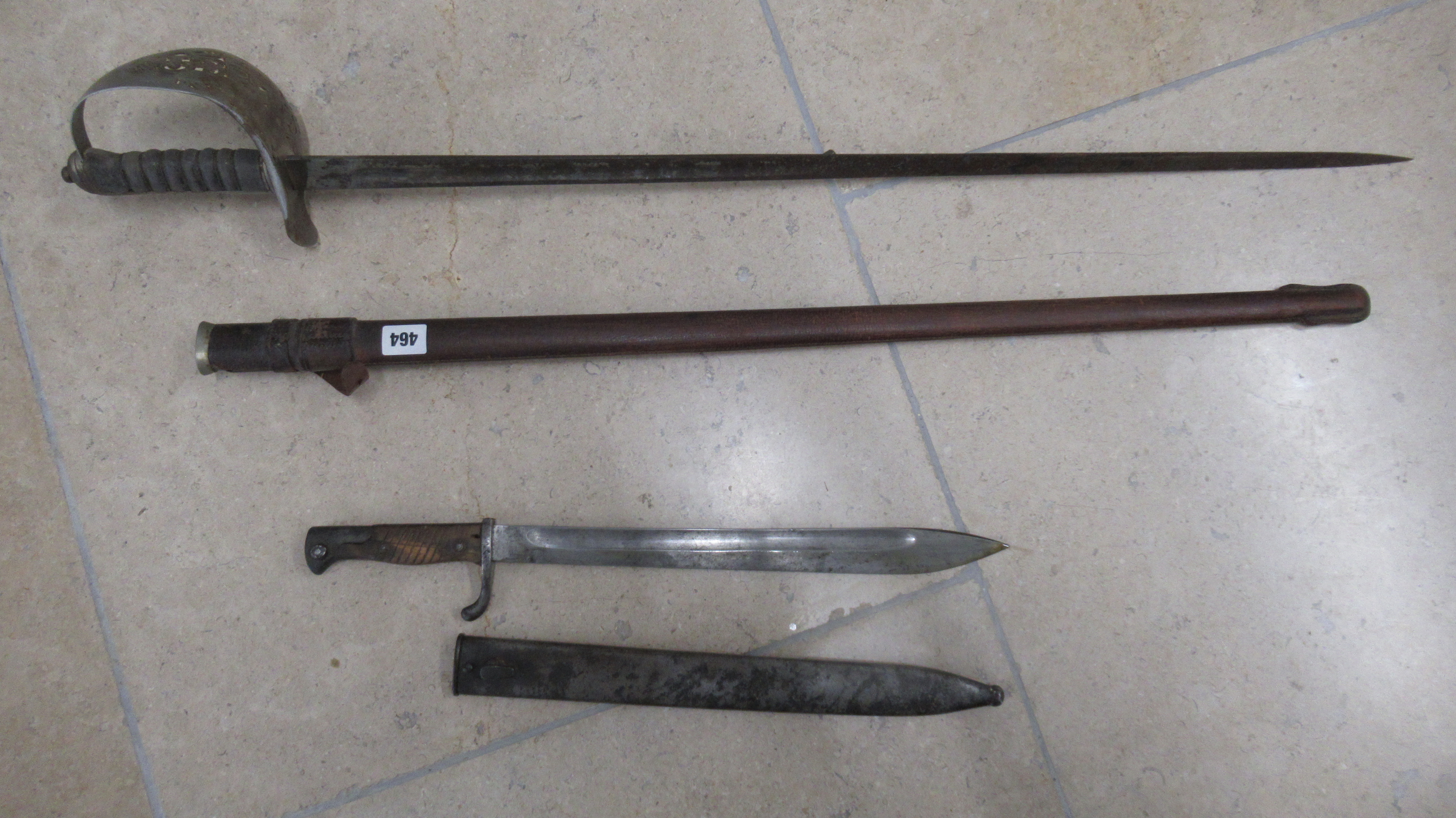 A sword and scabbard and a bayonet
