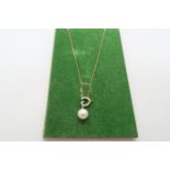 A 9ct yellow gold pearl and diamond pendant on 22 inch chain - ex jewellers stock, as new