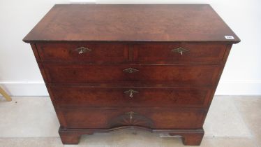 An 18th century style burr walnut chest with a cross banded top over two short and three long