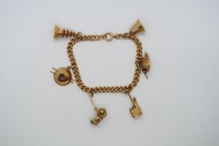 An approx 14ct yellow gold charm bracelet with 6 charms, approx 18.3 grams
