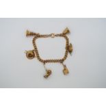 An approx 14ct yellow gold charm bracelet with 6 charms, approx 18.3 grams