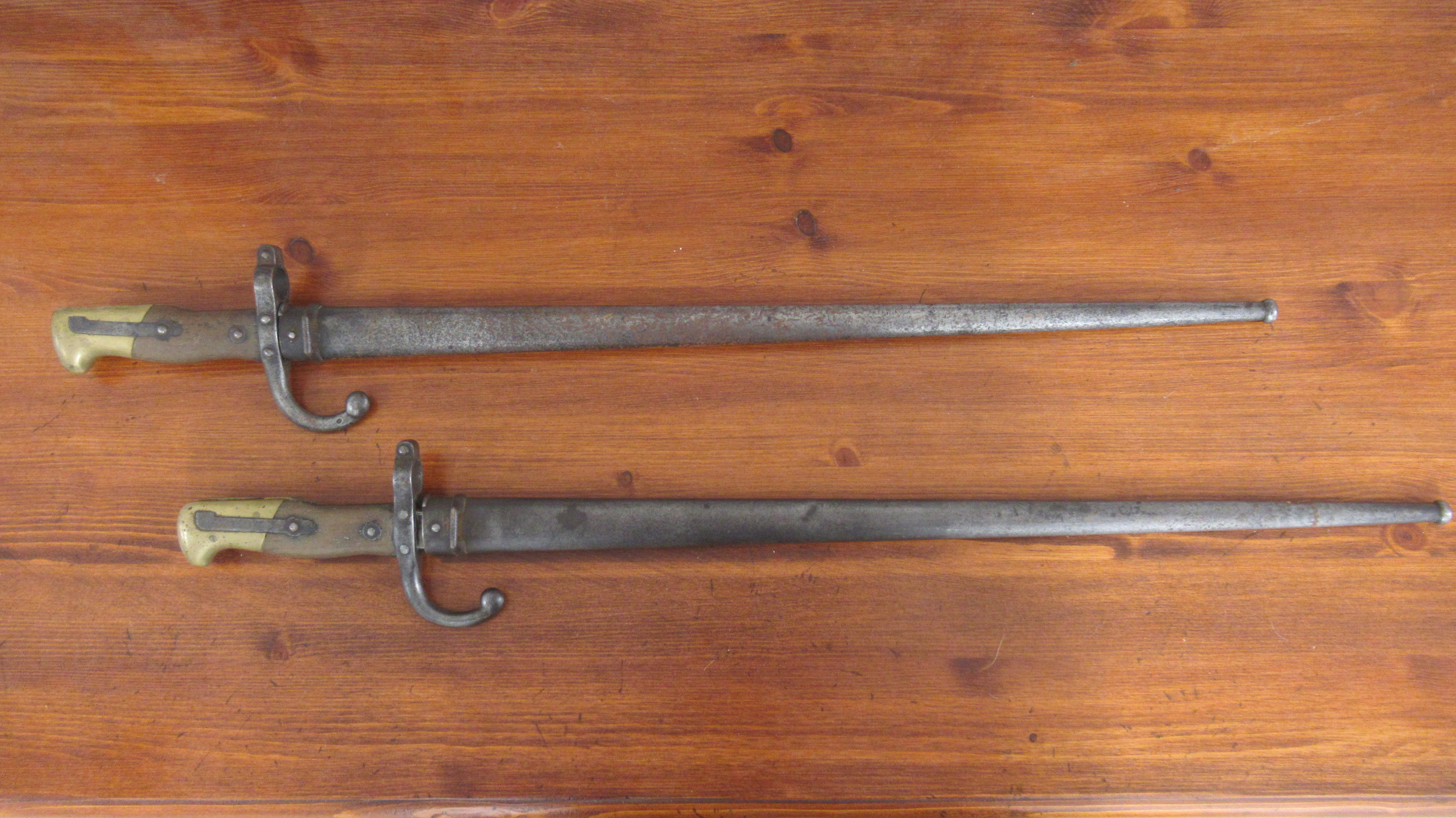 Two French 1874 pattern gras bayonets dated 1877 and 1879, 51cm blades with steel scabbards