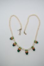 An Indian pearl and emerald necklace - The single string of even pearls set with six drops of hi
