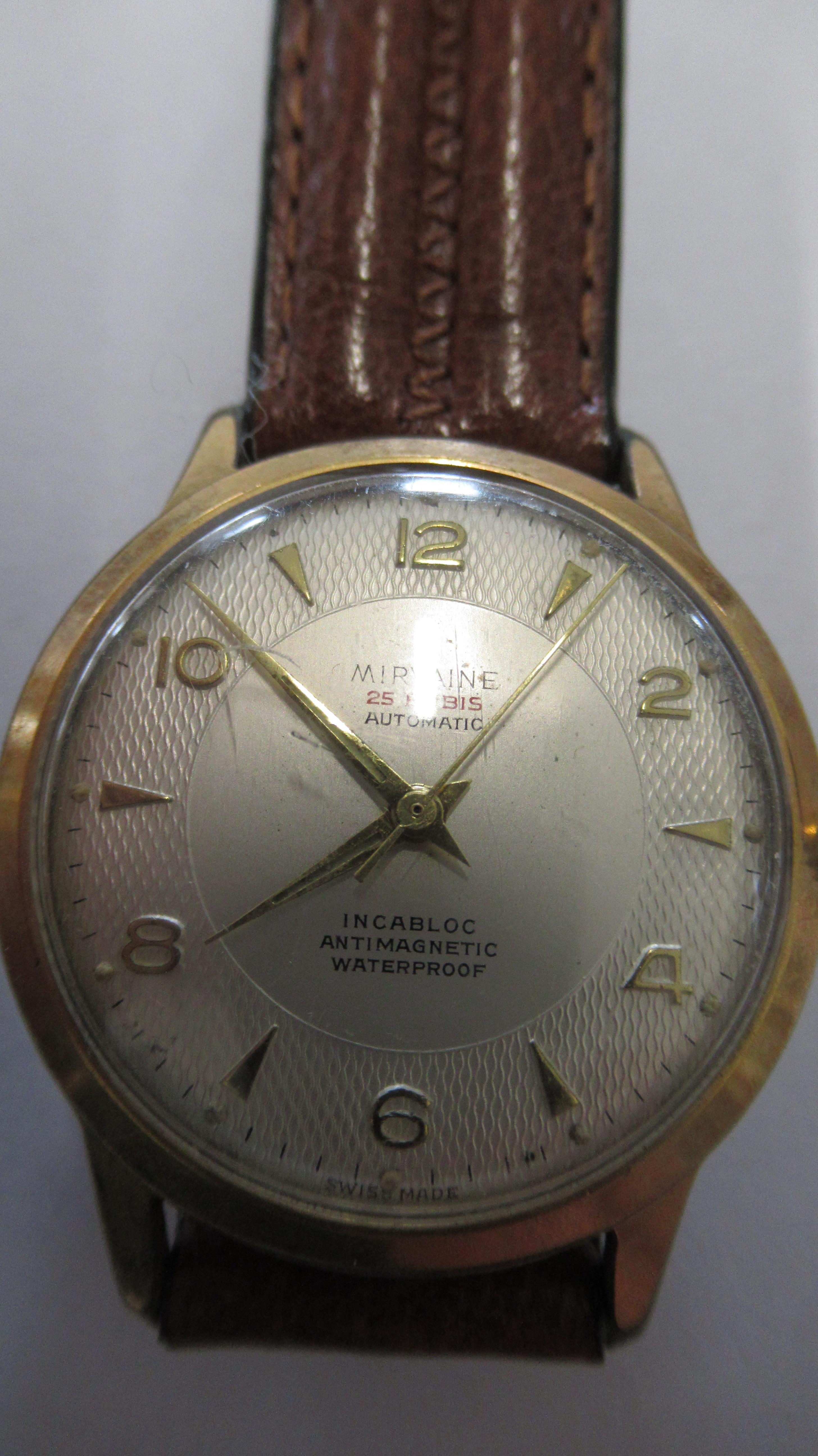 A gents Mirvaine auto with second hand on brown leather strap - working in the saleroom - case