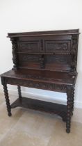 A 1930's heavily carved oak side cabinet - Width 115cm x 140cm