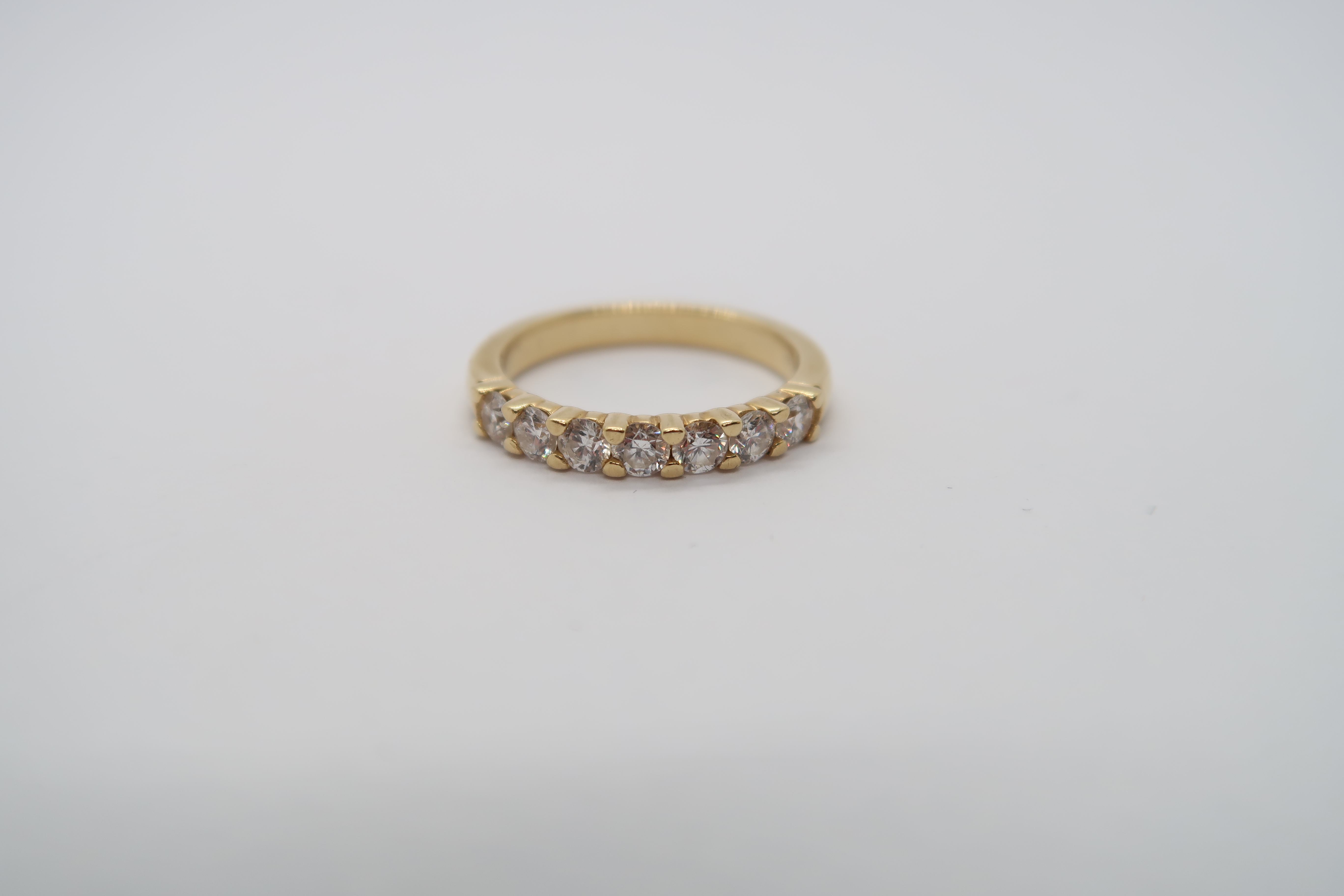 A seven stone diamond half eternity ring set in 18ct hallmarked yellow gold