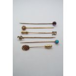 Four gold tie pins, 3.8 grams with one silver and one other