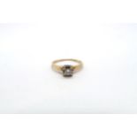 An illusion set 14ct yellow gold and diamond solitaire ring with chip - ring size M - 1.9 grams