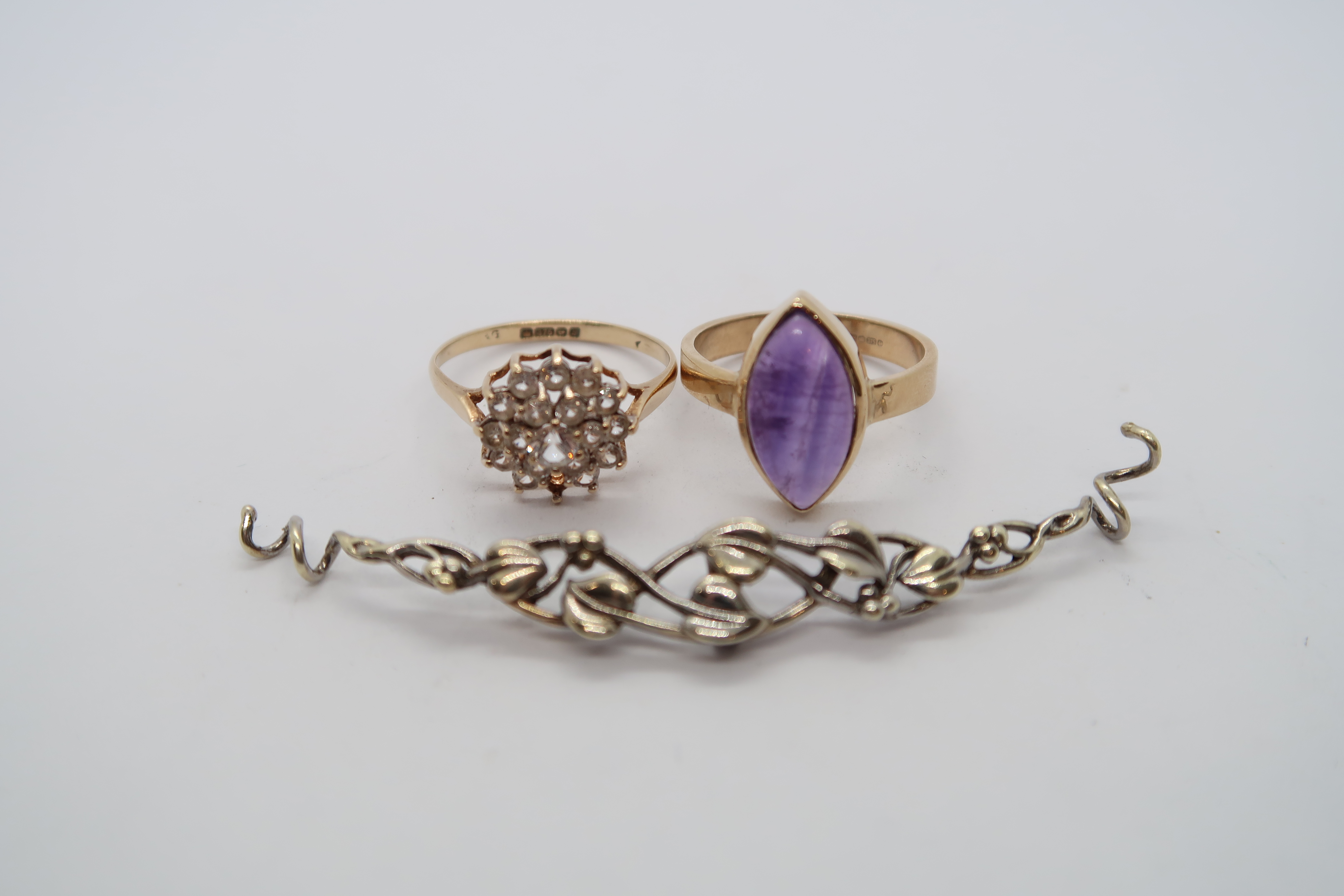 A hallmarked 9ct yellow gold ring with oval cabochon amethyst, size O/P, and another ring size P,