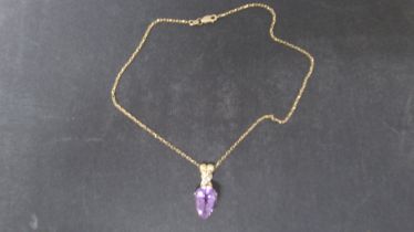 A hallmarked 9ct yellow gold pear shaped amethyst pendant on a 9ct hallmarked chain, pendant 3.