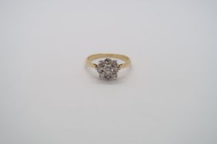 A good quality 18ct yellow gold and platinum 9 stone diamond cluster ring, diamonds are well