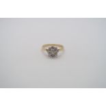 A good quality 18ct yellow gold and platinum 9 stone diamond cluster ring, diamonds are well