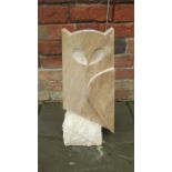 A hand carved stylised owl made from Ancaster weatherbed limestone with a Clipsham limestone base,